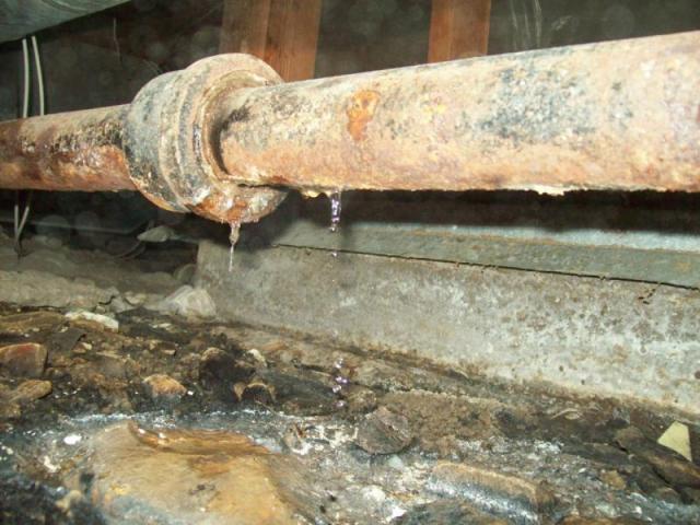 Leaking waste pipe in the crawl space area.